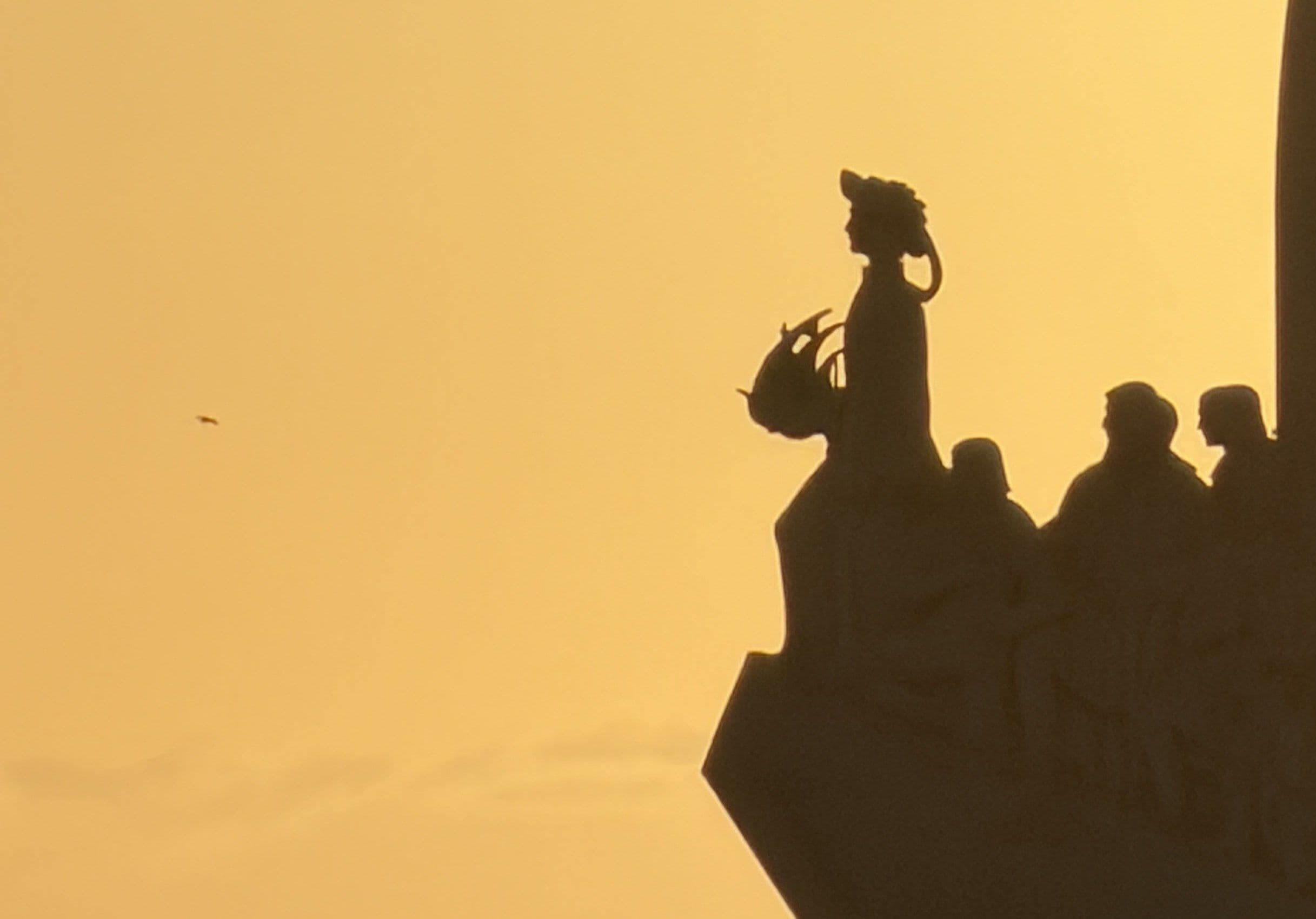 The Padrão dos Descobrimentos at golden hour — Henry the Navigator at the prow, the explorers behind him, over the Tejo in Lisbon
